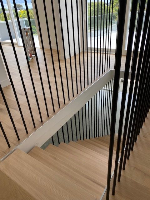 Vertical steel balustrade screen over timber floor