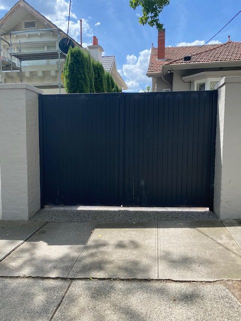 Dark steel security gate to driveway