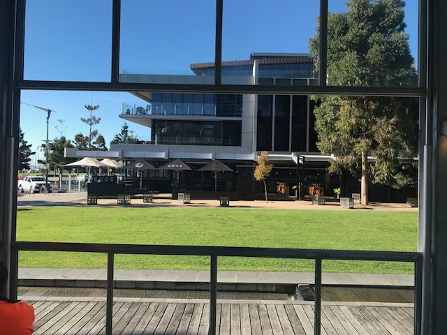 Commercial glazed building with deck and lawn