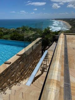 Frameless glass pool fencing above the coast